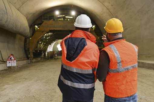 two workers looking into a tunnel